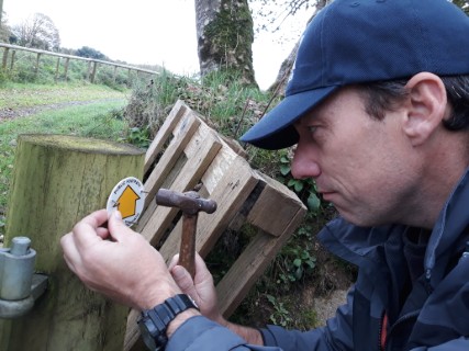 John adding a waymark to a footpath near Camelford whilst checking one of the routes